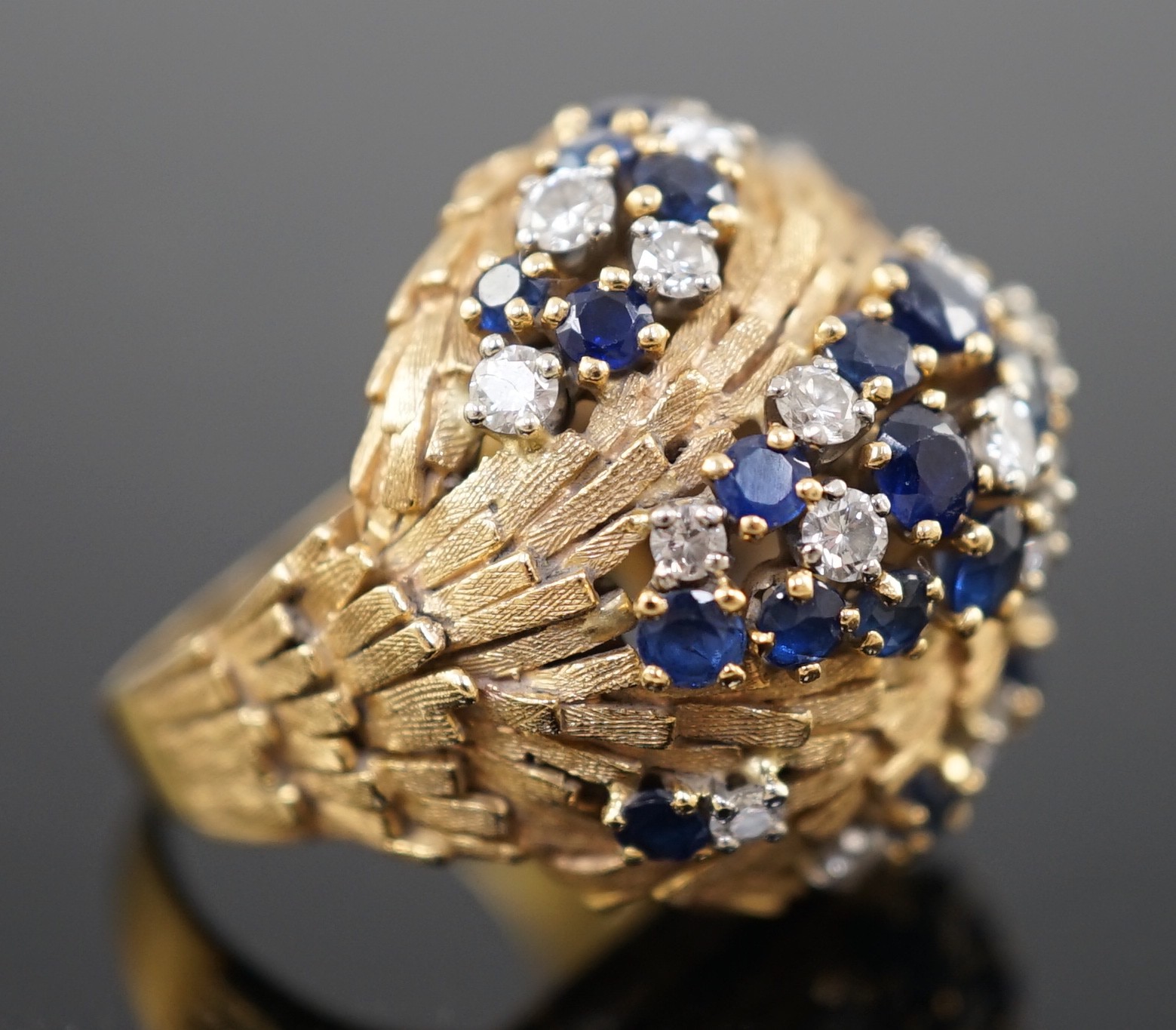 A mid 20th century textured 18ct gold, sapphire and diamond cluster set domed dress ring, by E. Meister, Zurich